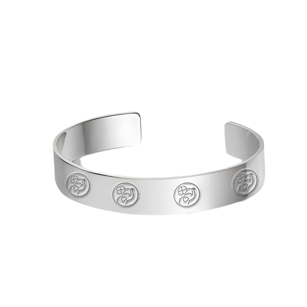 Silver bracelet with engraved symbols on a white background