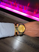 Gold stainless steel cuff bracelet with crystal accents engraved with a Gold watch on a wrist 