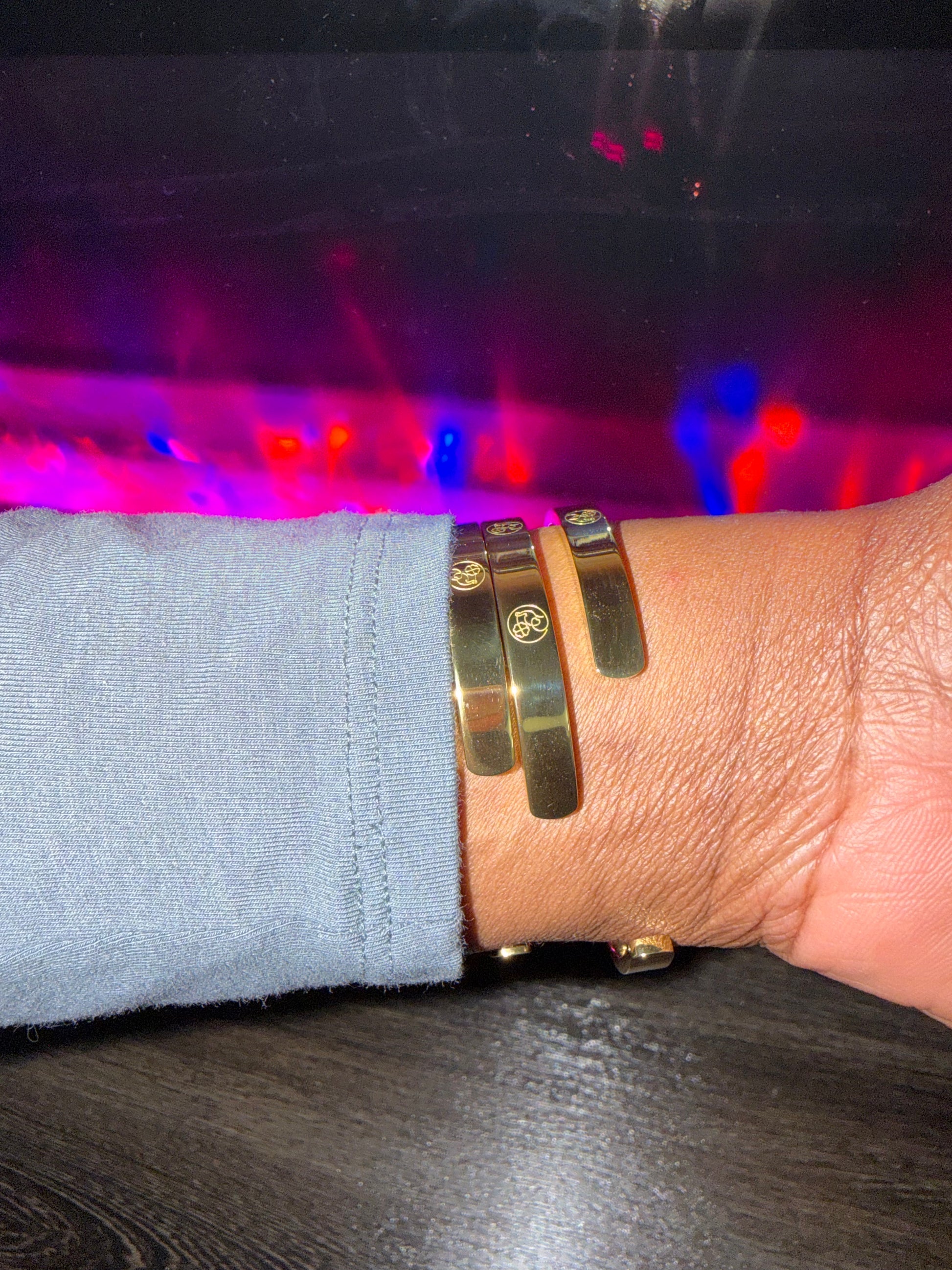 Close-up of a wrist wearing gold cuff bracelet back view 