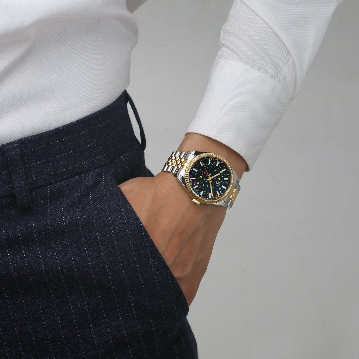 Seychelles Rainbow Dial Two-Tone Watch styled on wrist with professional outfit
