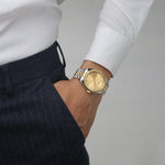 watch with a gold sunray dial and a silver mixed metal bracelet designed by RJ Royalty with baguette markers.