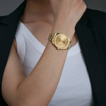 Gold 38mm stainless steel unisex watch with magnified date and gold dial and markers 