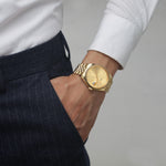 Gold 38mm gold unisex watch with magnified date and sunray dial on male model