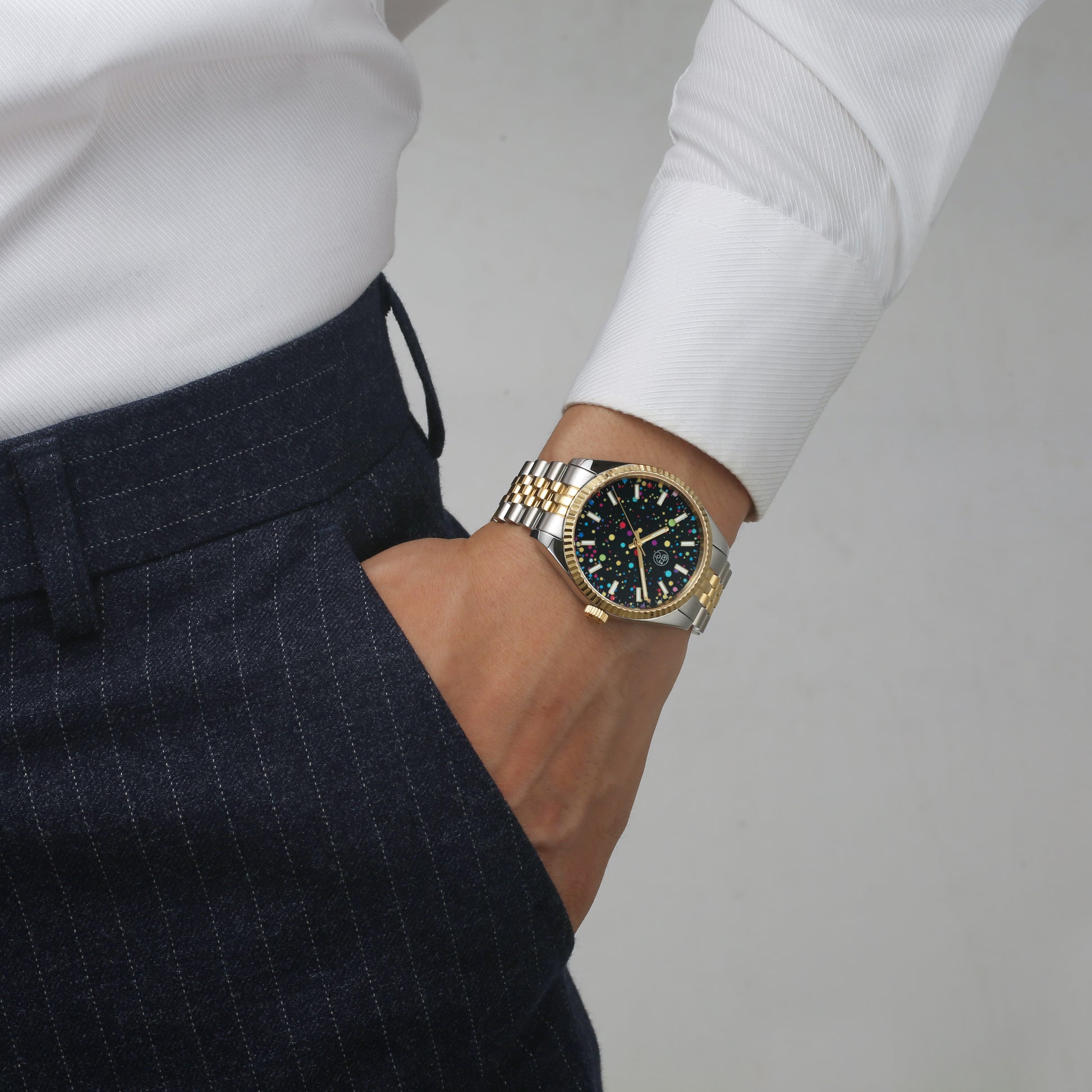 Male corporate model wearing multi color galaxy dial two tone watch