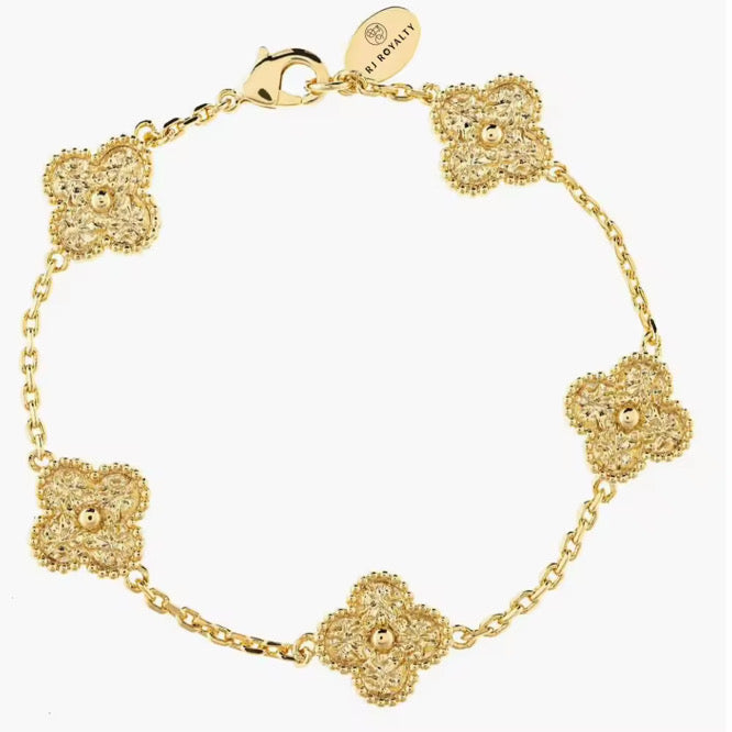 A gold clover bracelet featuring a four-leaf clover design 