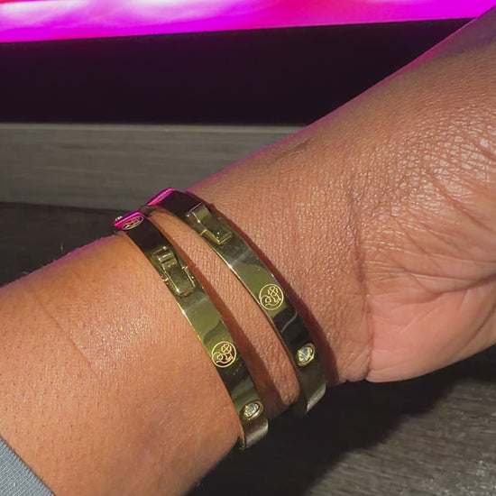 two gold bracelet with simulated diamond accents on female wrist