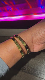 two gold bracelet with simulated diamond accents on female wrist