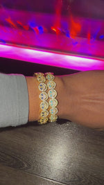 smiley bracelets stacked with blue diamonds