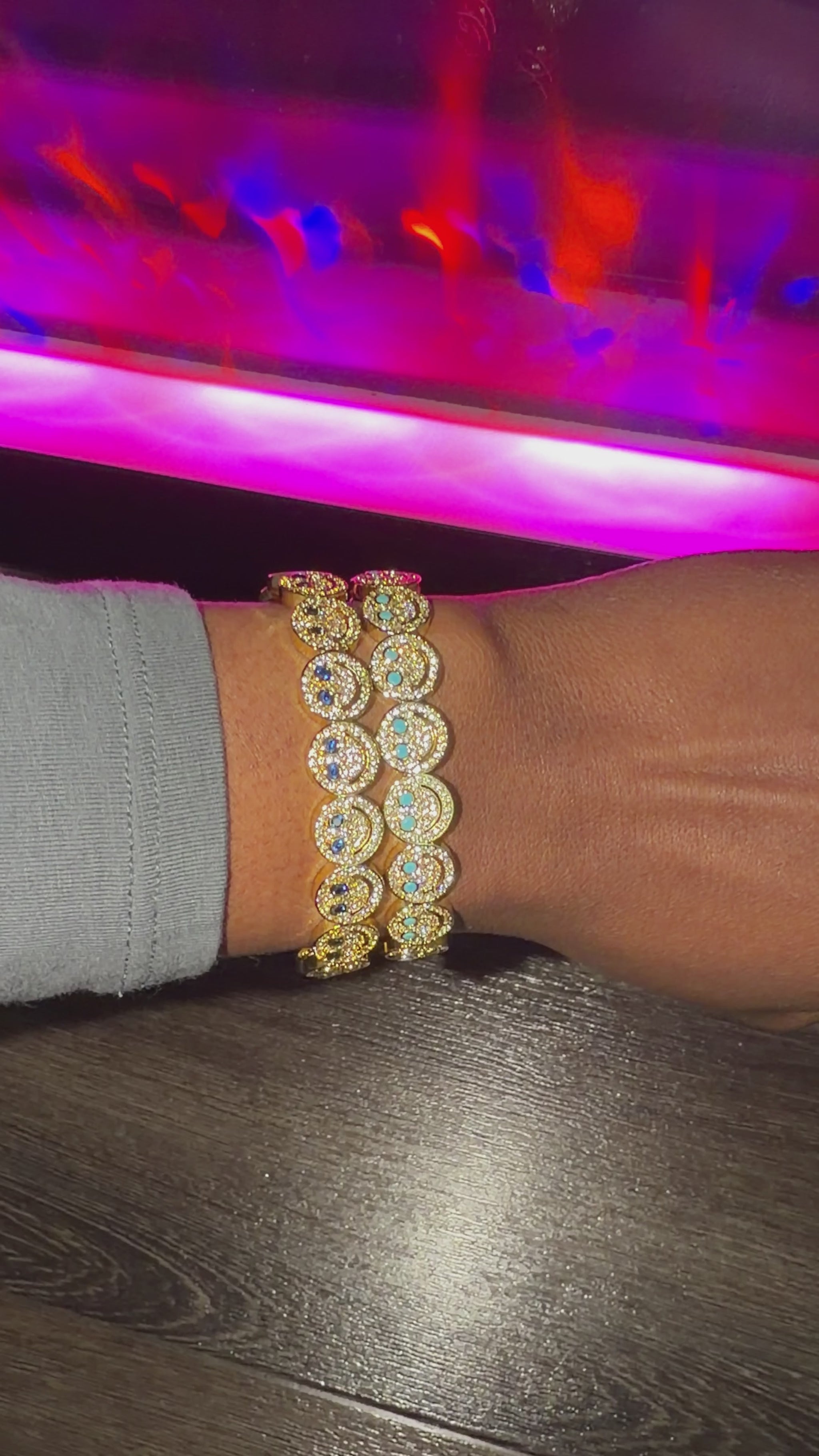 smiley bracelets stacked with blue diamonds