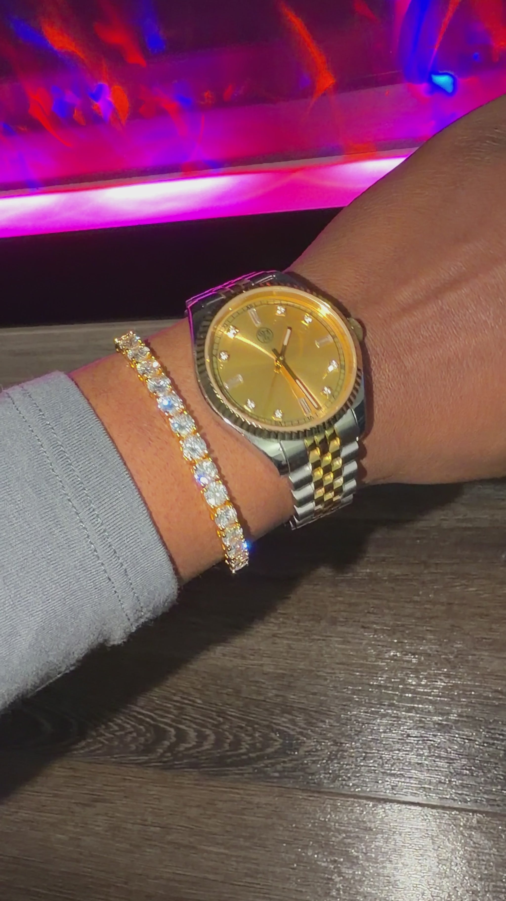 Gold tennis bracelet stacked with a rj royal gold dial watch 